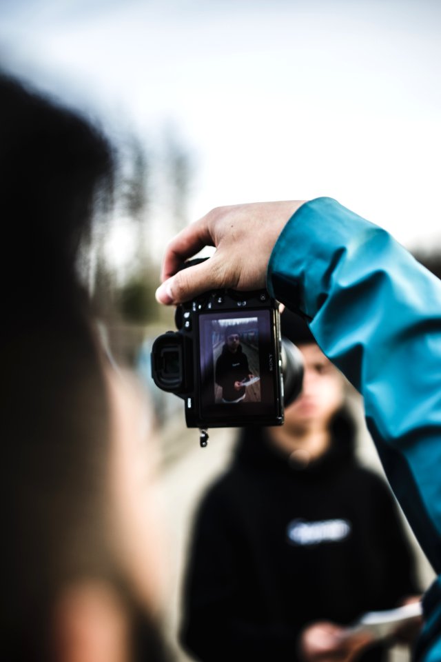 person holding black DSLR camera