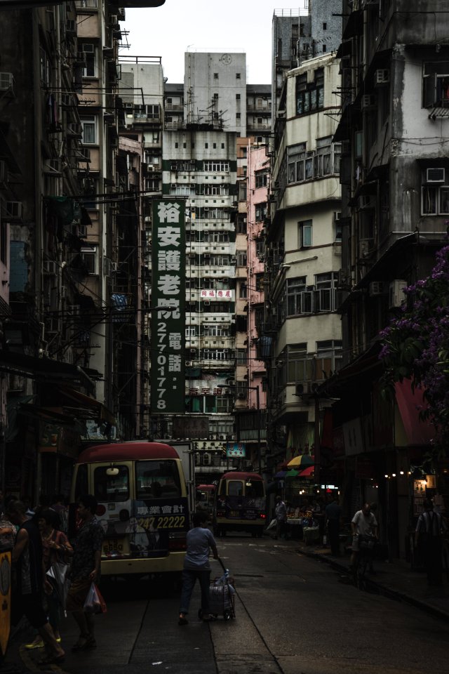 people walking in the street near high rise buildings