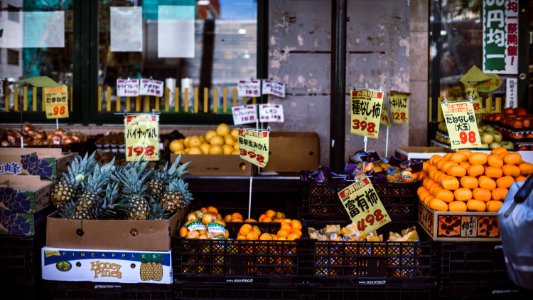 assorted fruits with labels on crates photo