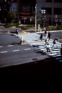 people walking on pedestrian lane across road during daytime photo