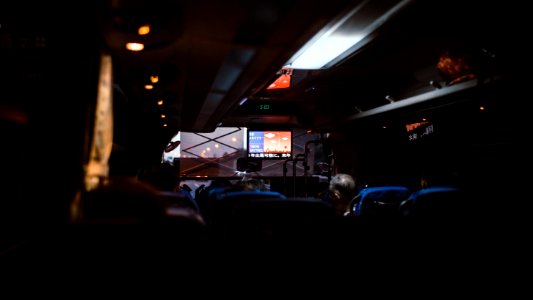 The dim interior of a coach driving through Tokyo