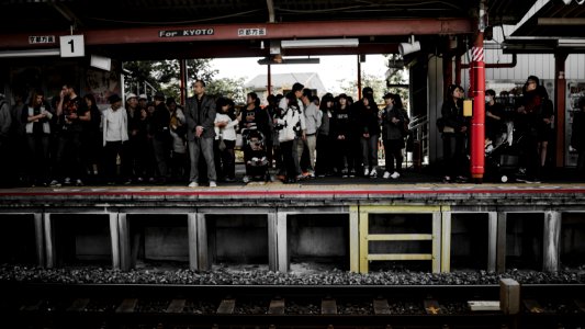 people standing in train station photo