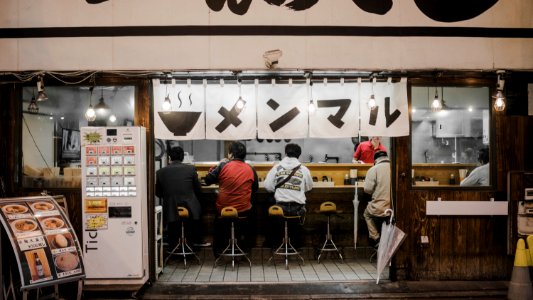 four person sitting on bar stools photo