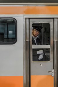 man wearing suit jacket inside train photo