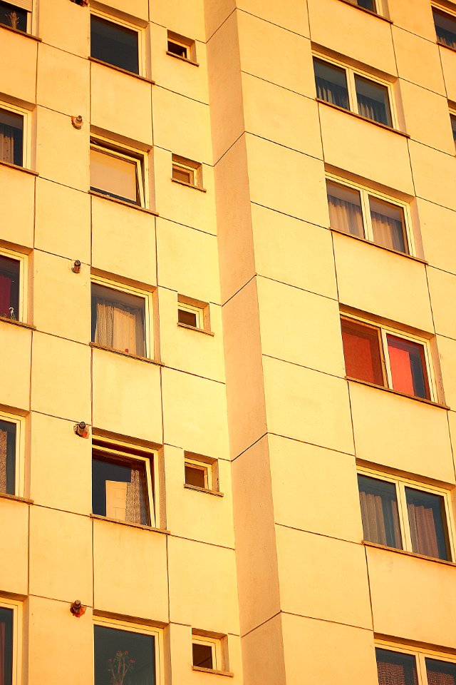 beige concrete building with glass windows photo