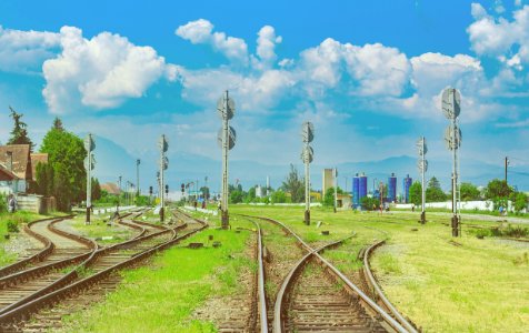 brown train rail under blue sky during daytime photo