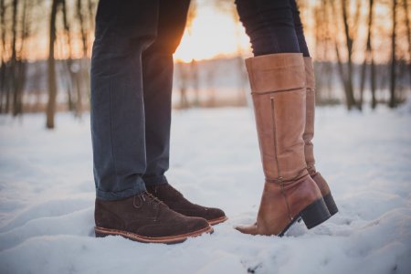 two person in brown boots and shoes on snowy forest photo