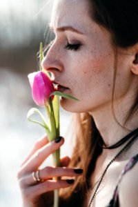 woman holding pink rose bud photo