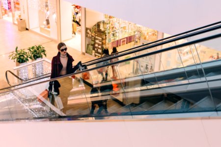 woman riding escalator photo