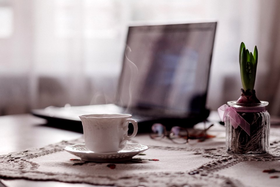 white ceramic mug on table photo