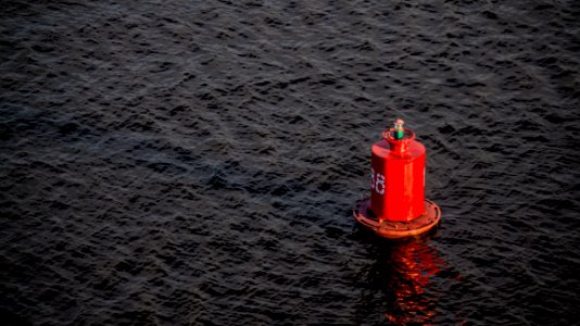 red buoy on body of water
