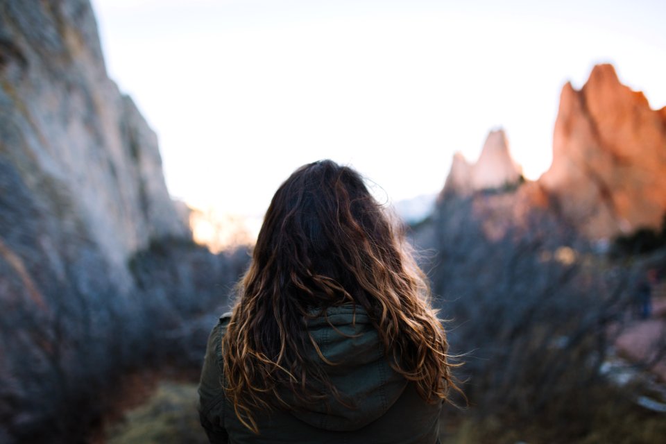 woman facing mountains at daytime