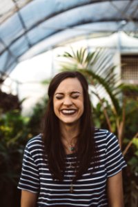 woman smiling while standing in garden photo