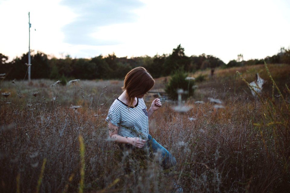 woman walking on brown leaf plant at daytie