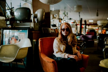 woman sitting on sofa wearing sunglasses photo
