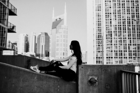 grayscale photography of woman sitting photo