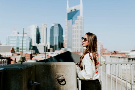 woman standing near hand rails during daytime photo