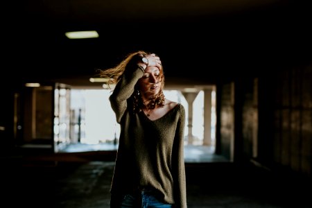 woman walking oh street while holding forehead