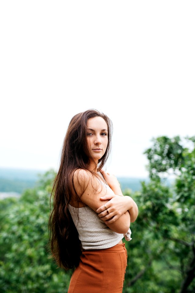woman wearing white knitted top and brown bottoms