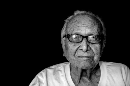 grayscale photography of man wearing shirt and eyeglasses photo