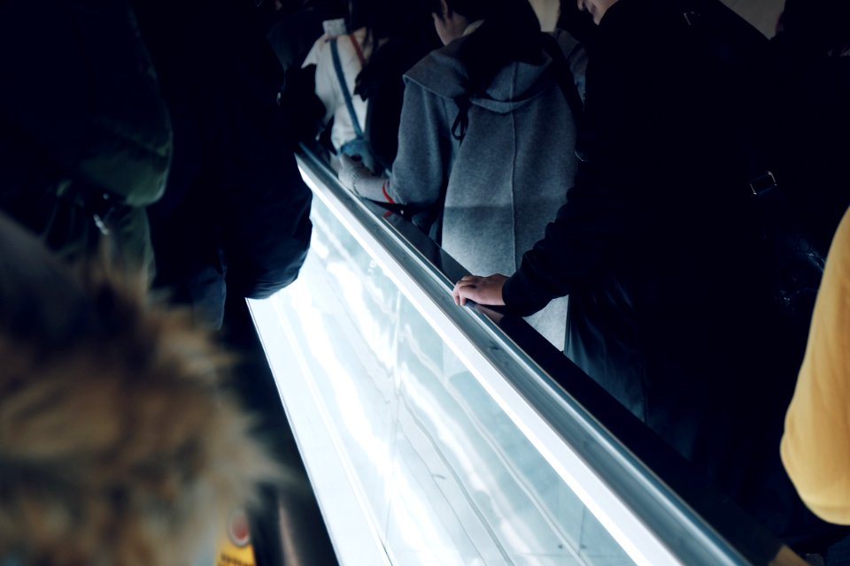 people on elevator inside building