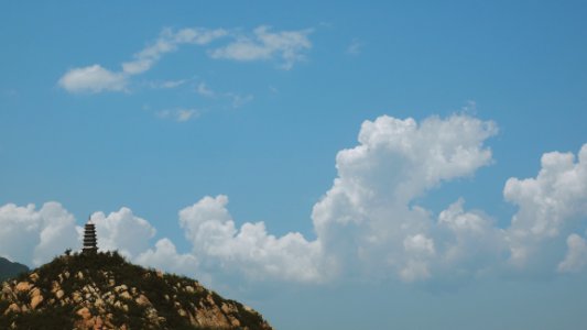 white clouds over black pagoda during daytime