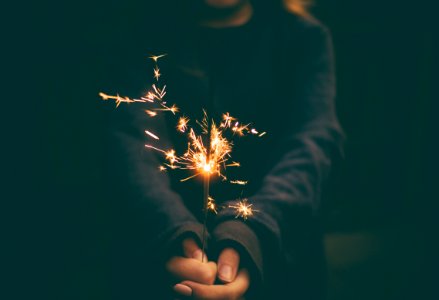 person holding sparkler photo