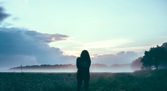woman standing field silhouette photo