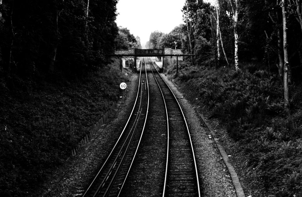 grayscale photo of train rail