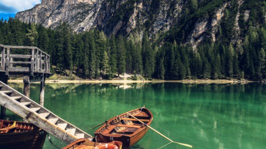 brown canoe docking on gray wooden staircaes photo