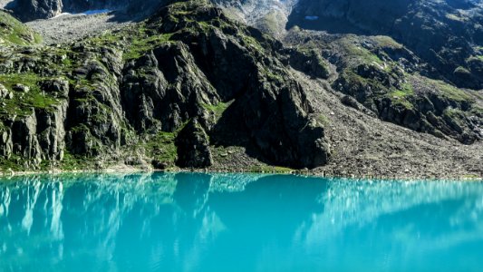 lake along body of mountain photo