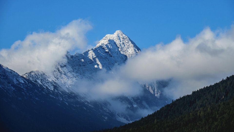 snow covered mountain under blue sky photo