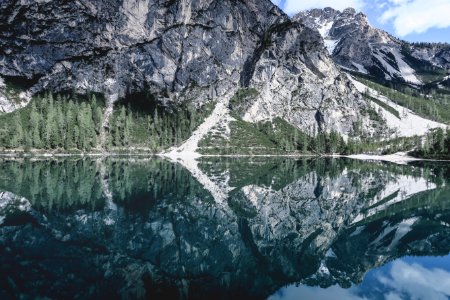gray rocky mountain beside lake during daytime photo