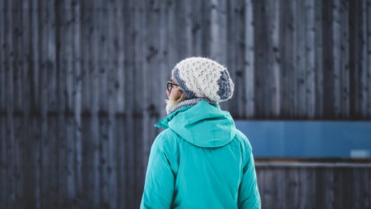 selective focus photography of woman facing wall