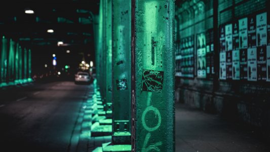 green steel fence near cars during daytime photo