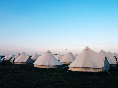 white tents on grass field under clear blue sky