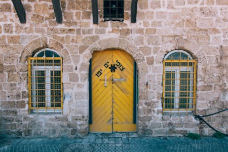 brown concrete building with brown wooden door photo