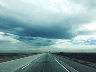 empty road under cloudy sky photo