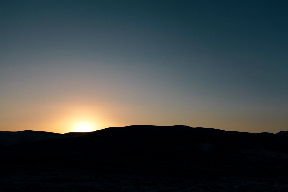silhouette of mountain during golden sky