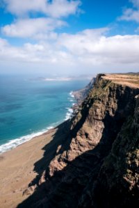 brown cliff beside ocean
