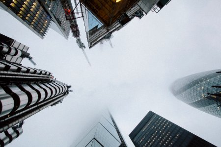 low angle photo of high rise building covered with fog photo