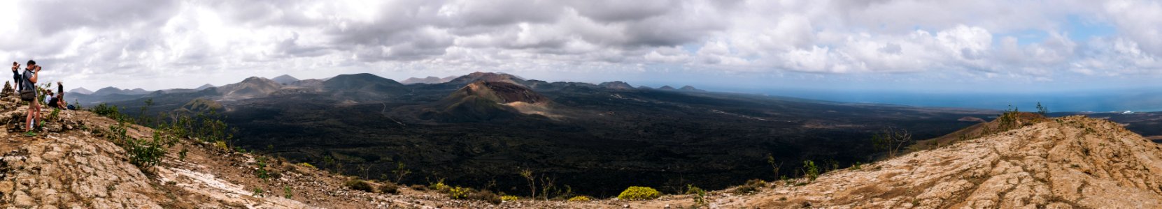 panorama photography of mountain range under cloudy sky
