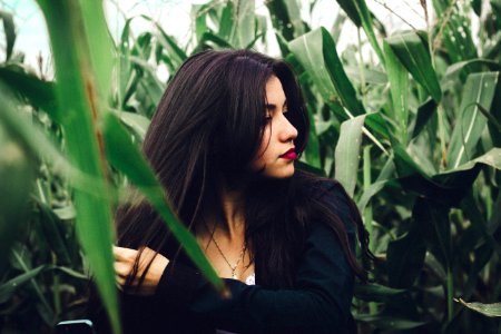 woman wearing black long-sleeved top in cornfield at daytime photo