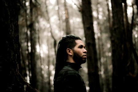 man standing beside trees