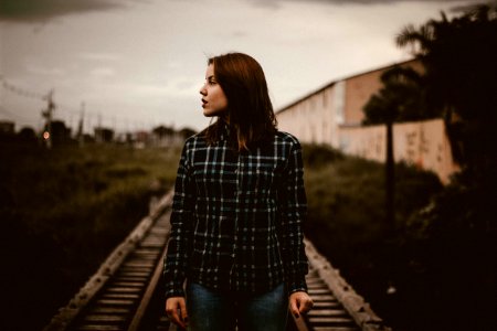 woman standing on train rail track photo