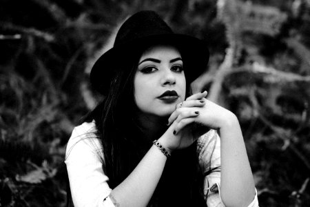grayscale photo of woman sitting on ground