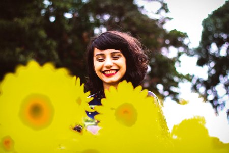 woman standing on yellow flowers photo