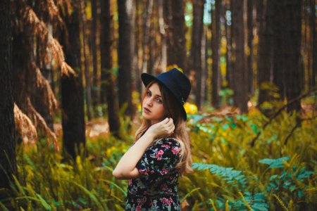 woman standing near green grass and trees at daytime photo