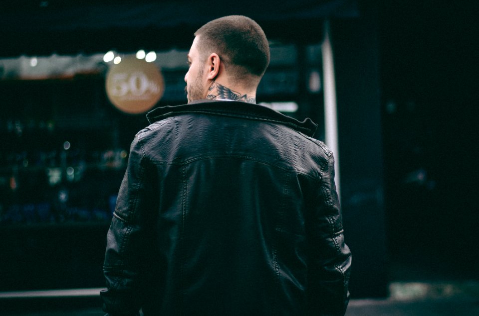 man wearing black leather jacket