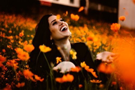woman laughing on flower field photo